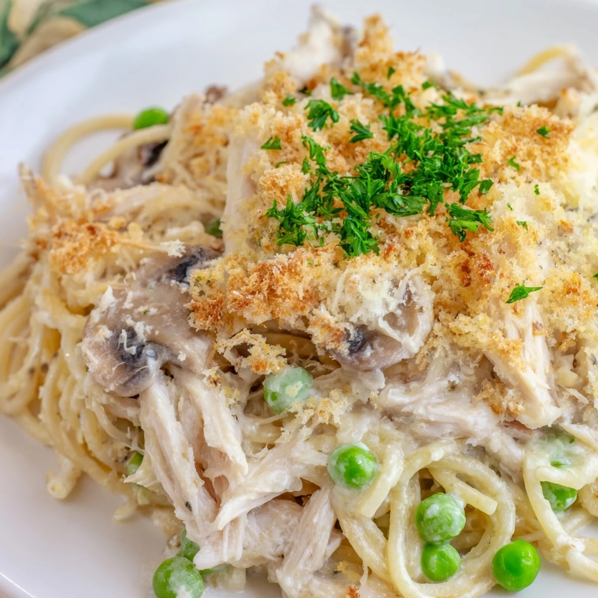 Fresh parsley garnish on a creamy Turkey Tetrazzini casserole for dinner.