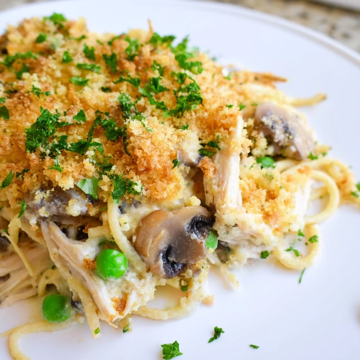 Golden-brown Turkey Tetrazzini with peas and mushrooms bubbling from the oven.