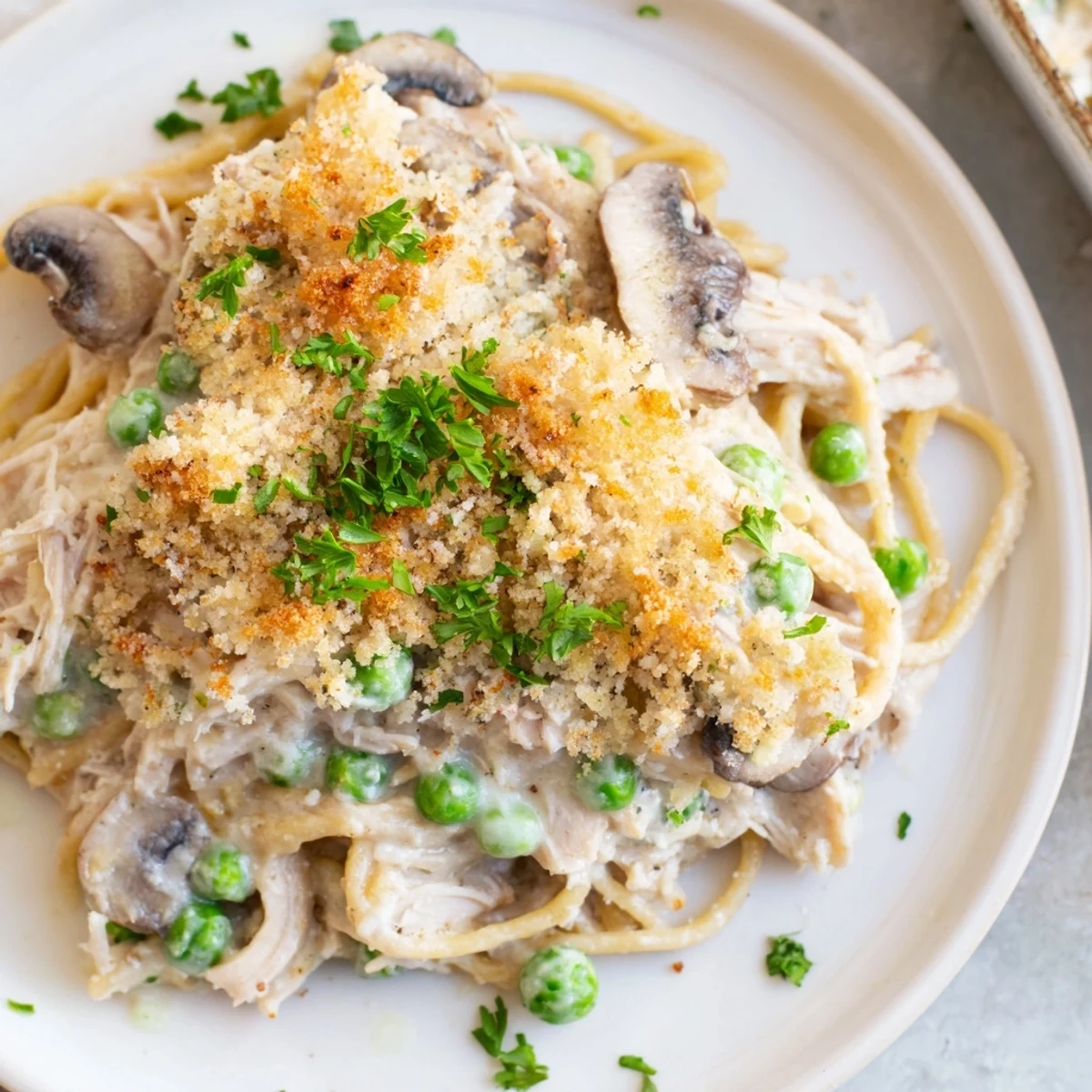 Serving of Turkey Tetrazzini with a spoon, showcasing its creamy texture.