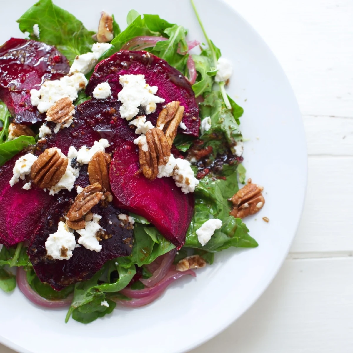 Roasted beet and goat cheese salad on mixed greens, topped with toasted pecans and red onion, drizzled with balsamic vinaigrette.  