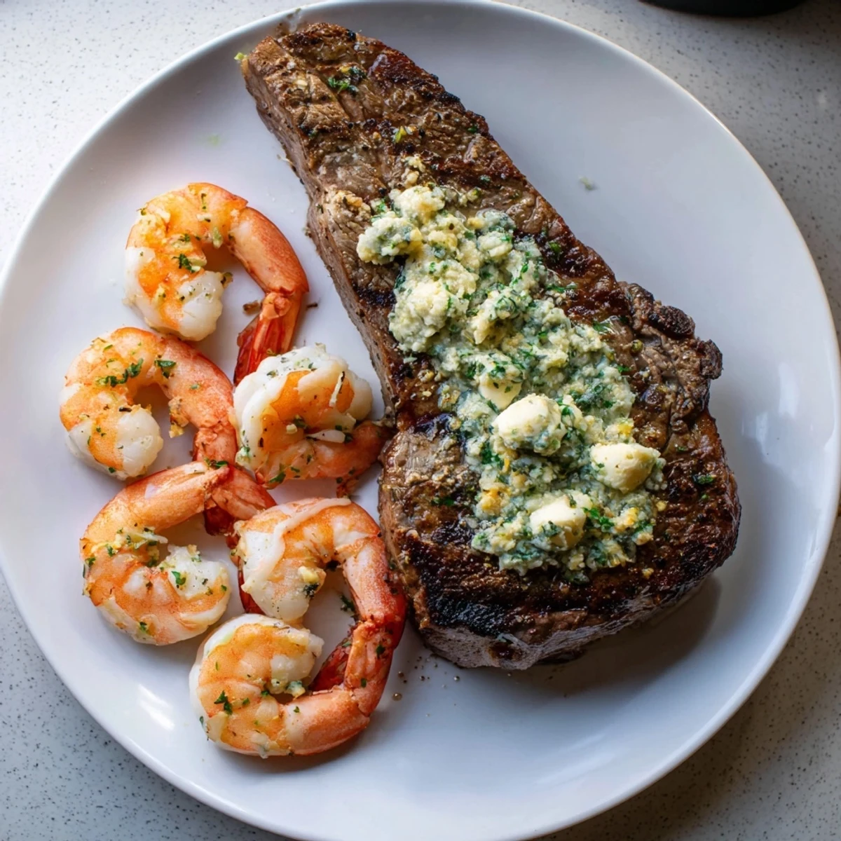 Perfectly seared steak and succulent shrimp served hot with a rich garlic butter finish.
