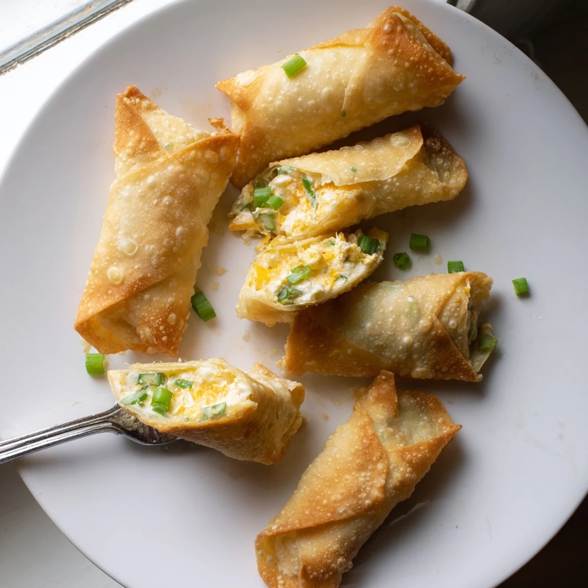 Fresh diced jalapeños and creamy cheese filling visible inside each Mini Jalapeño Popper Egg Roll.