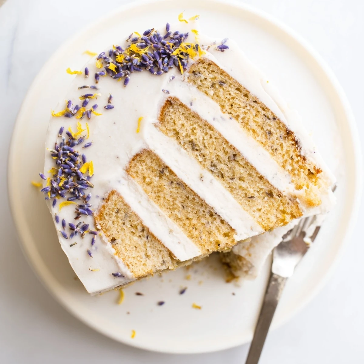 Freshly baked London Fog Cake with Earl Grey & Lavender showing smooth frosting swirls and an inviting, aromatic dessert presentation.