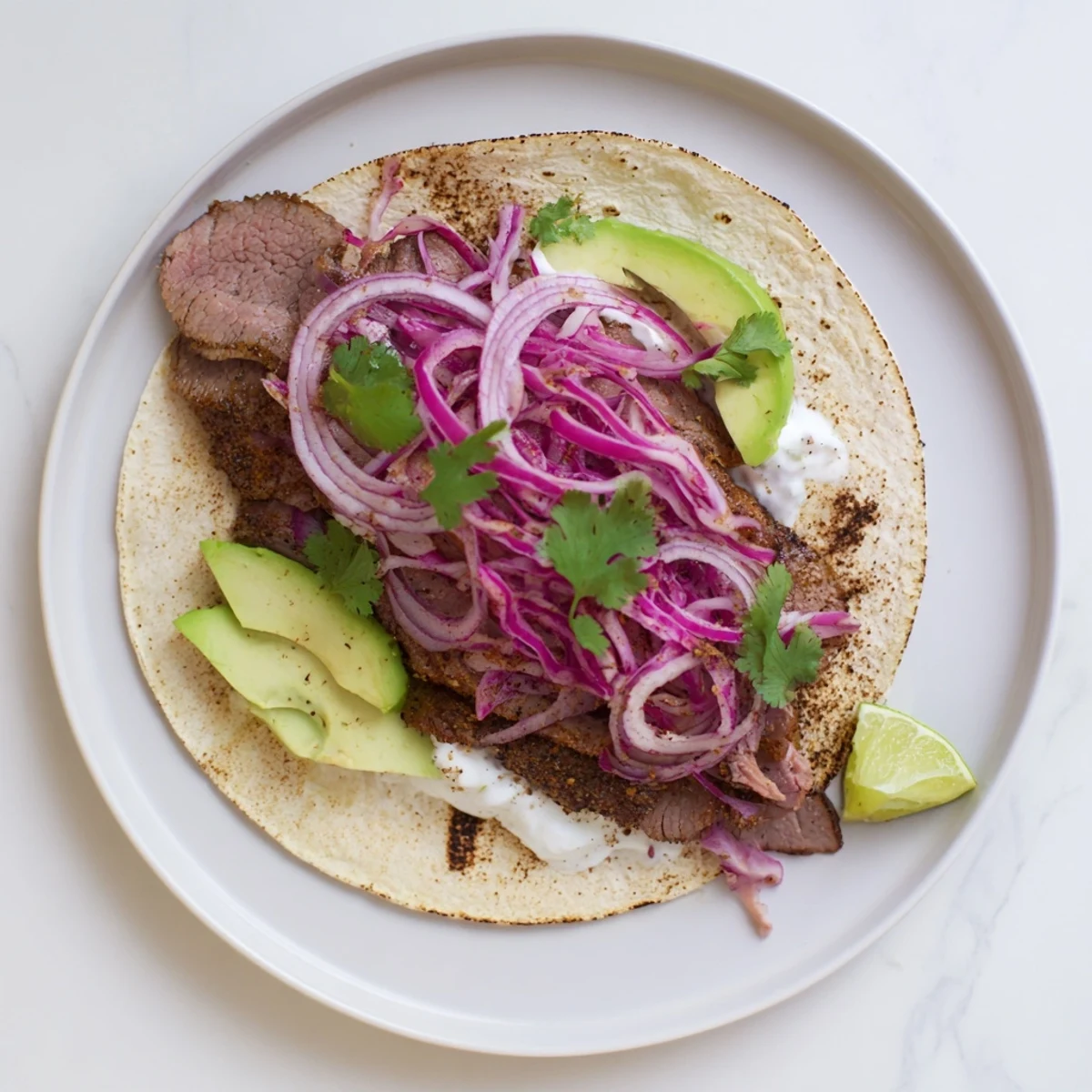 Golden roasted cumin crusted leg of lamb sliced into soft tacos with fresh toppings