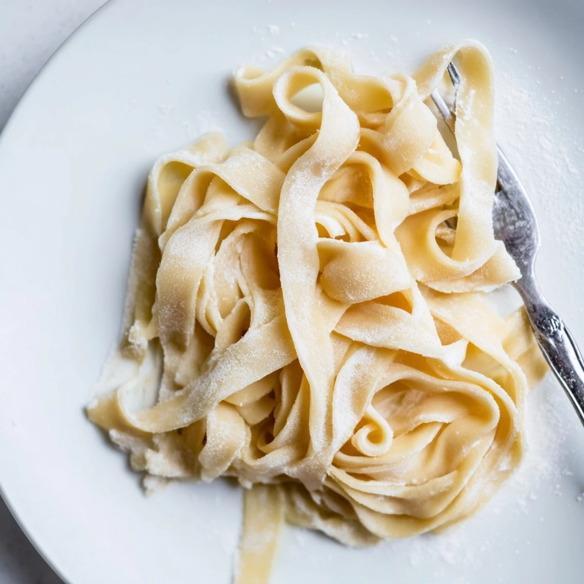 Golden strands of homemade sourdough pasta tossed with fragrant basil pesto sauce
