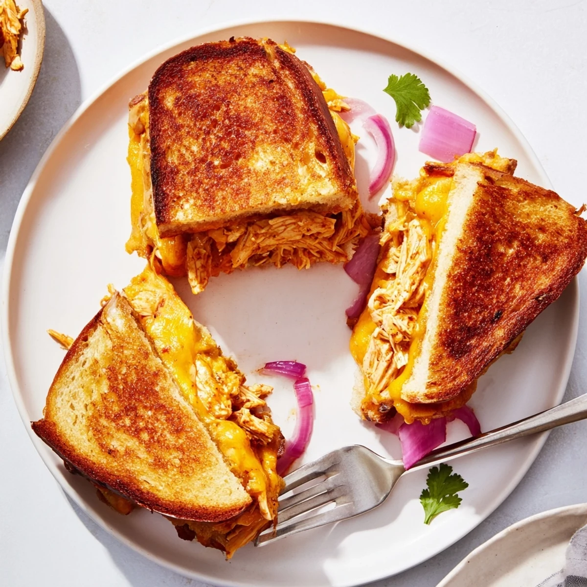 Savory BBQ chicken grilled cheese featuring tender shredded meat and gooey blended cheese on buttered toast
