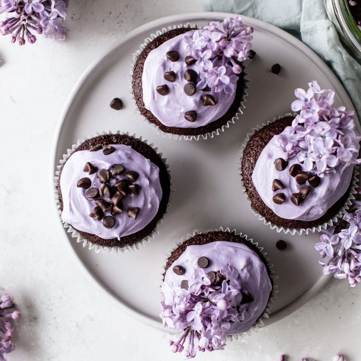 Moist chocolate cupcakes infused with lilac syrup, finished with delicate edible flowers