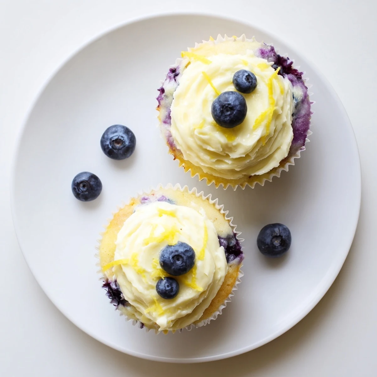 Fluffy lemon blueberry cupcakes fresh from the oven with tangy cream cheese frosting