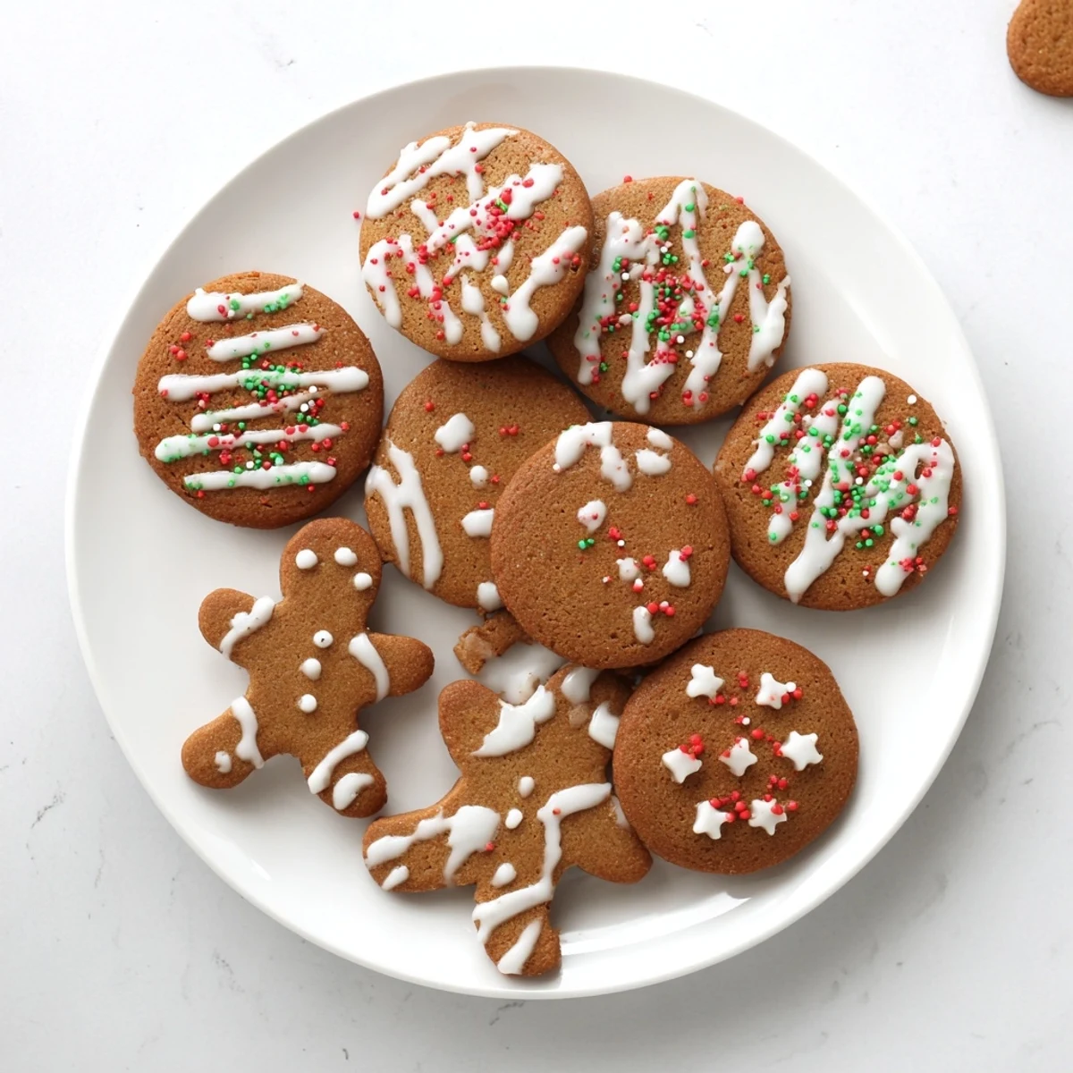 Soft spiced gingerbread cookies cut into holiday shapes and ready for Christmas decorating with royal icing.