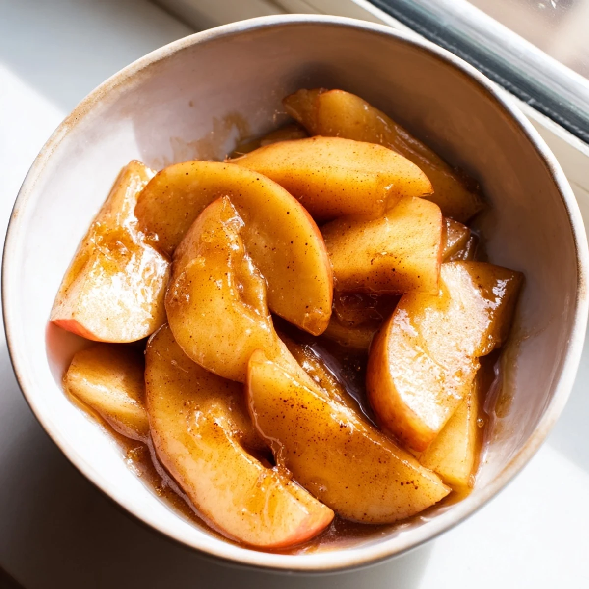 Warm spiced apple slices swimming in cinnamon brown sugar sauce, freshly cooked in the Instant Pot
