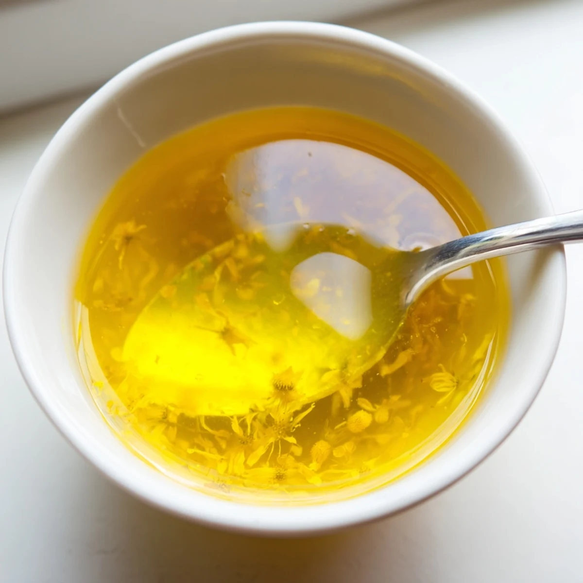 Sunlit jar of homemade fresh dandelion jelly glowing with floral sweetness