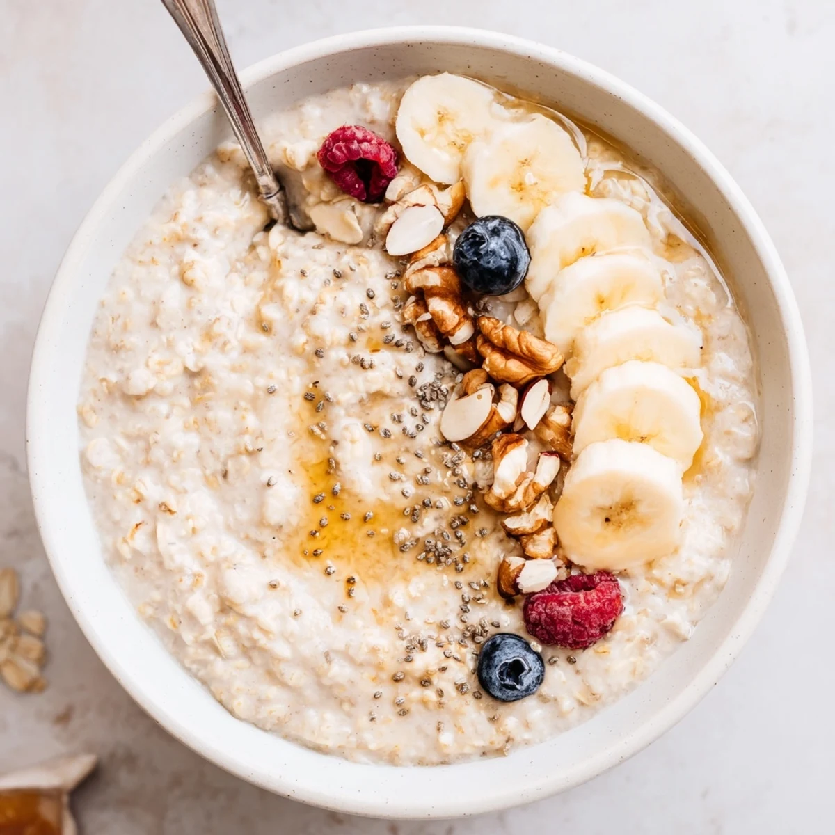 Creamy Protein Oatmeal swirled with maple, served in blue breakfast bowl