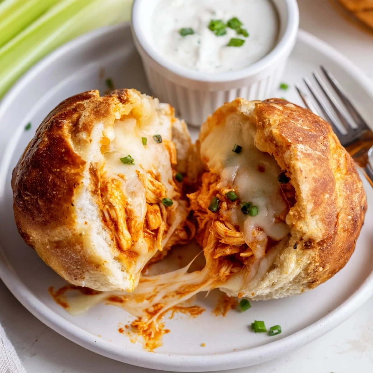 Golden Buffalo Chicken Mozzarella Bombs oozing spicy filling, served with ranch.