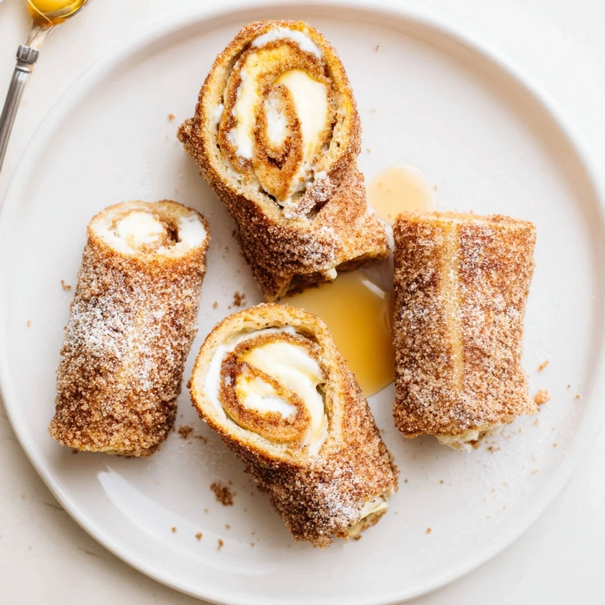 Skillet fried Cinnamon Roll French Toast Roll Ups, crispy edges, ideal with maple syrup