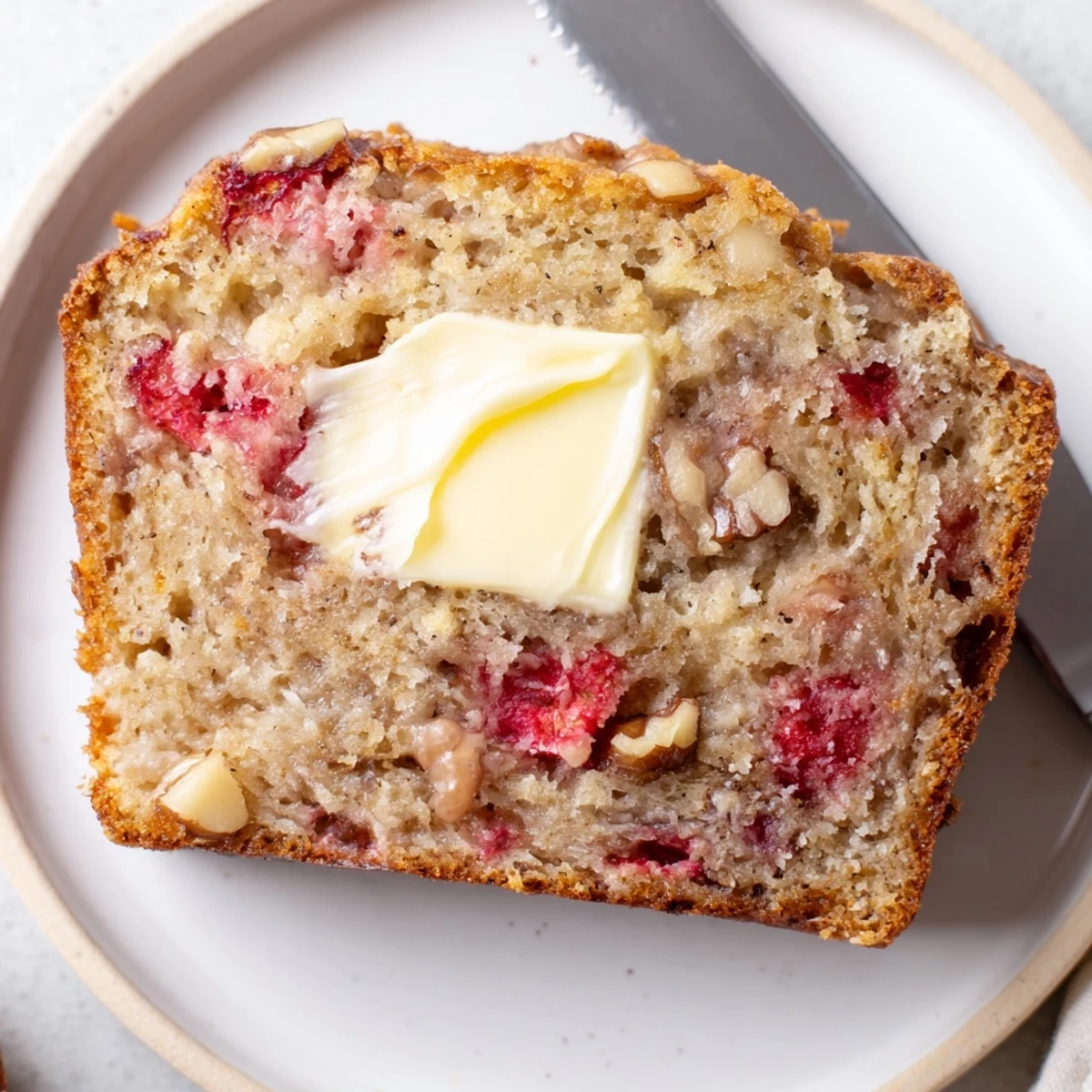 Homestyle Strawberry Banana Bread Recipe studded with chopped strawberries, tender crumb, served warm