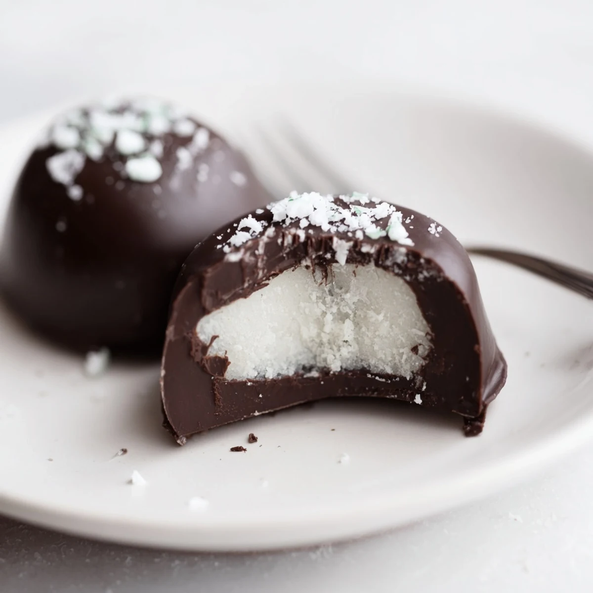 Homemade Peppermint Patties with glossy dark chocolate, chilled on parchment.