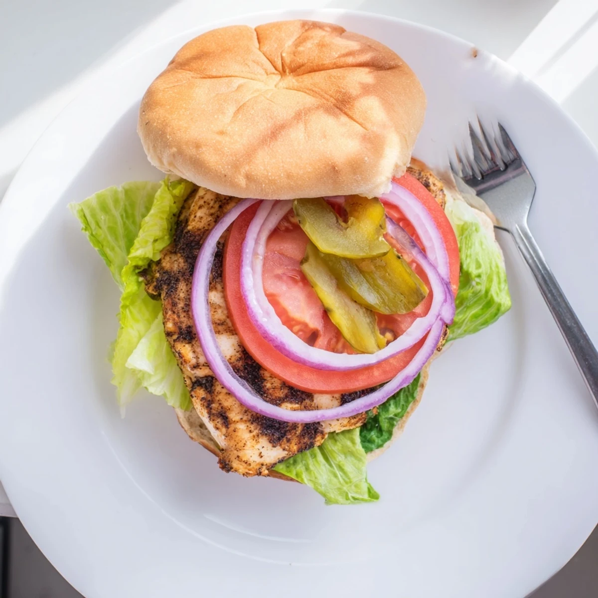 Juicy spice-marinated chicken breasts layered on Savory Spiced Chicken Sandwiches with crisp red onion and creamy mustard sauce