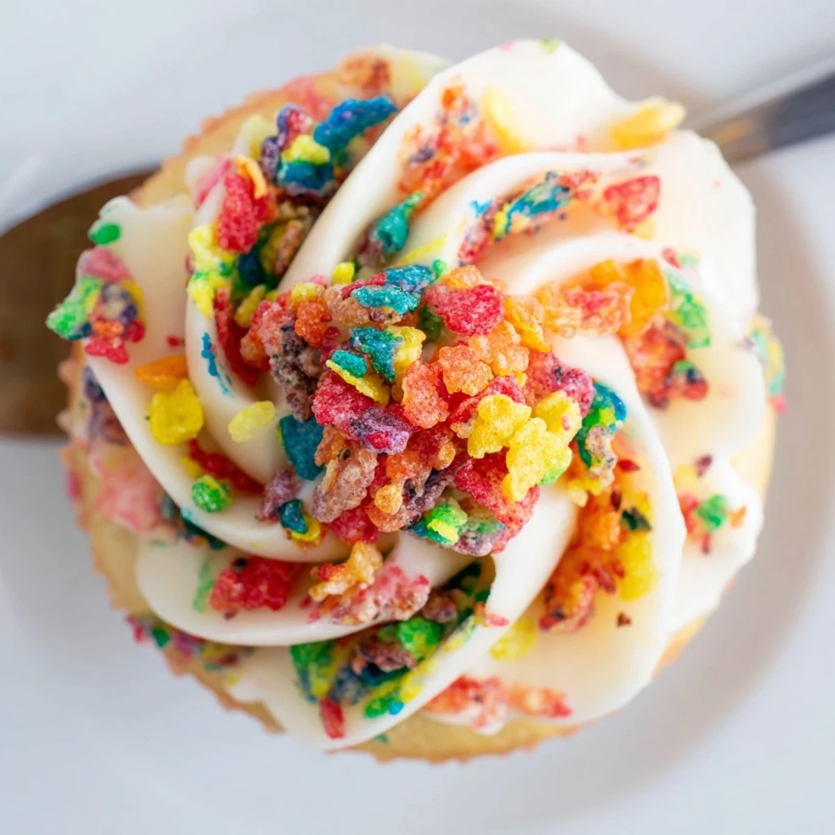 Fruity Pebbles Cereal Frosting piped on cupcakes, colorful crunch, creamy texture