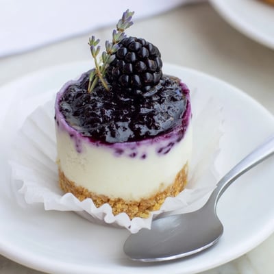 Velvety no bake mini blackberry lavender cheesecakes with buttery graham cracker crusts and fresh berries